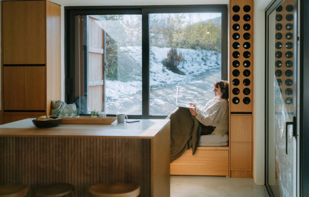 working professional by window snowy landscape